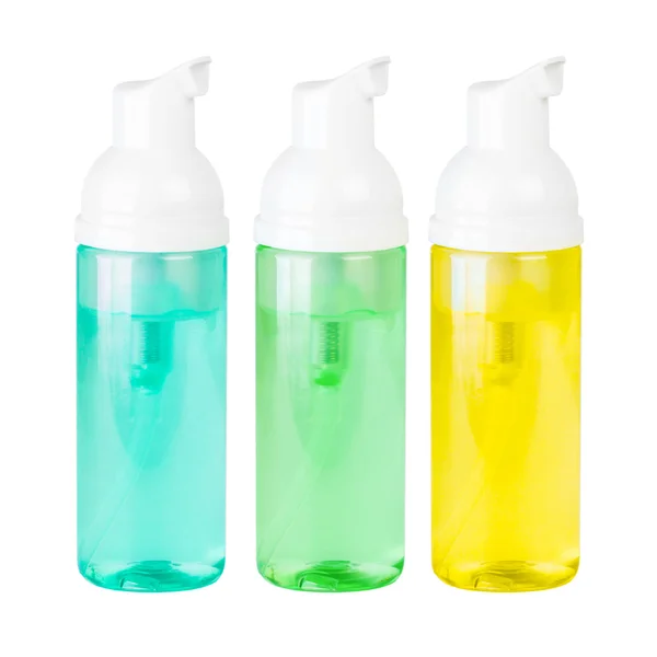 Три пляшки зеленого, жовтого і синього — стокове фото