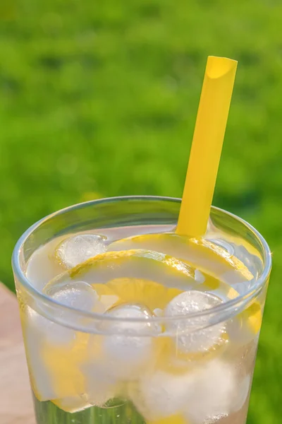 Glass of ice water with lemon slices — Stock Photo, Image