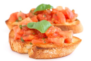 Klasik İtalyan bruschetta domates ve fesleğen kızarmış ekmek üzerinde.