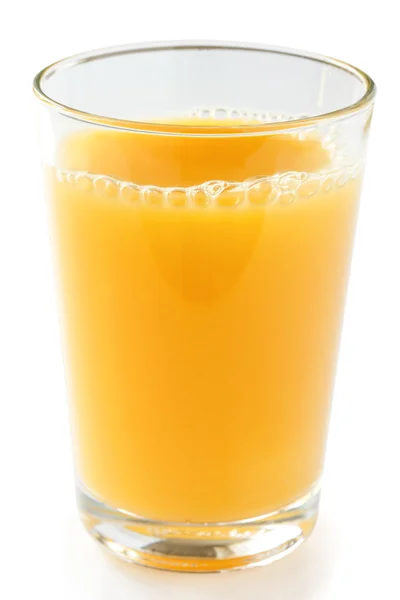 Single glass of orange juice on a white surface. Stock Picture