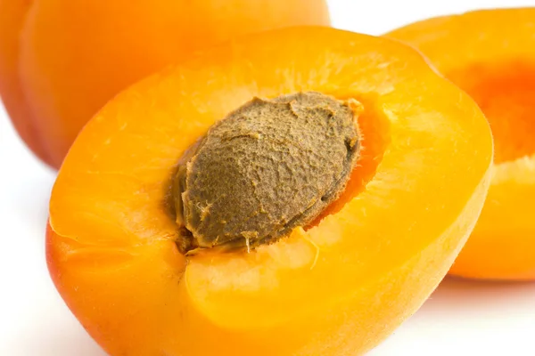 Detail of a ripe apricot cut open with stone visible. — Stock Photo, Image