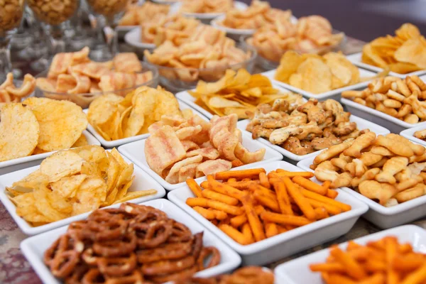 Many types of savoury snack in white dishes — Stock Photo, Image