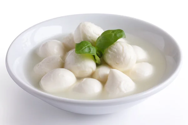 Kleine weiße Mozzarella-Bällchen in einer weißen Schüssel mit Flüssigkeit. — Stockfoto