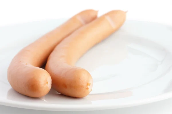 Two cooked frankfurter sausages on a plate with white background — Stock Photo, Image