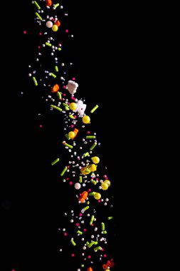 Sprinkle stream falling on a dark background