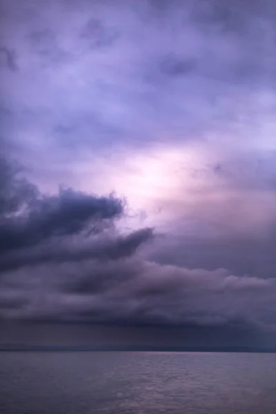 Moody and dark purple clouds over the ocean