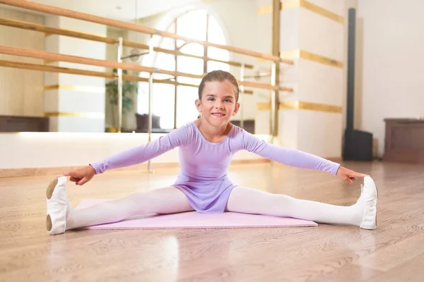 Beautiful Little Ballerina Lilac Leotard White Tights Doing Stretching Exercises — ストック写真
