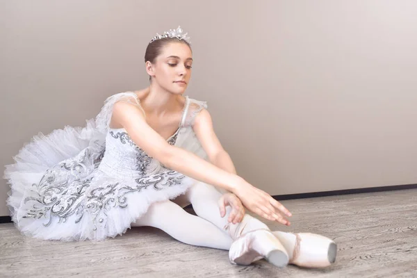 Cute Ballerina Sitting Floor Her Arms Outstretched Forward Practicing Ballet — ストック写真