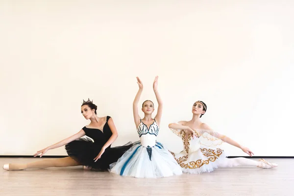 Three Young Ballerinas Perform Paired Exercises White Background Studio — kuvapankkivalokuva
