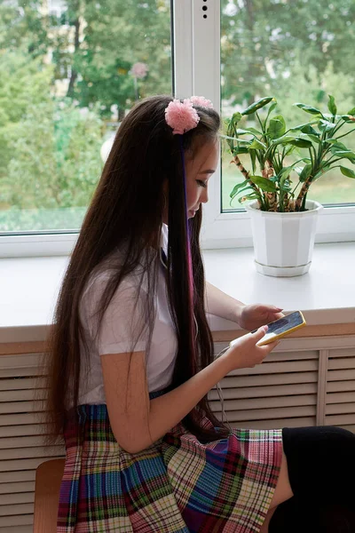 High school student is sitting on the windowsill. Anime style — Stock Photo, Image