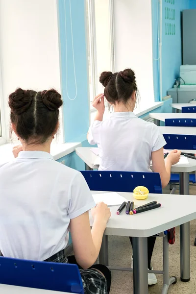 High school student writes in a notebook. — Stock Fotó