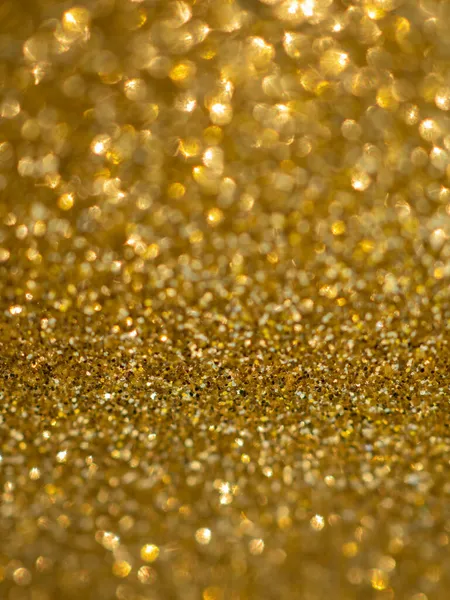 Et glitrende gult papir. Golden glitter lys bokeh abstrakt tekstur. Mønsterdesign. Sparkle tapet til jul. Brilliance flimrende paillet baggrund. Festtid. - Stock-foto