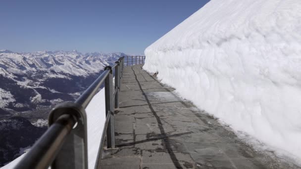 Snow Covered Sntis Path Terrace Tourist Filmed Walking White Backpack — Stockvideo