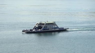 meilen location, zurich switzerland, august, 21, 2022 car and passenger ferry on lake zurich fully loaded with vehicles and passengers, daytime sunshine,backlight