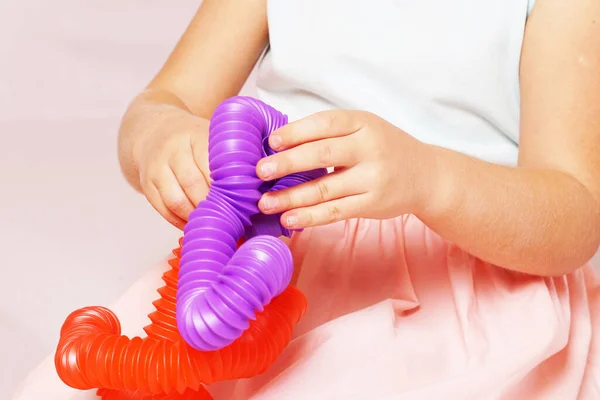 Child Plays Pop Tube Different Colors Pop Tube Yellow Purple — Stock Photo, Image