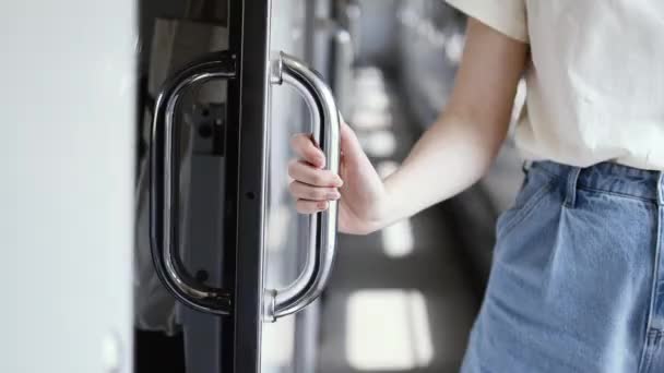 Female tourist hand closes the metal compartment door of the train. Travel and vacation concept — Stock Video