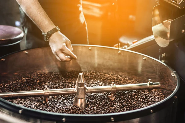 Fresh roasted coffee. Roasting process of coffee beans at factory