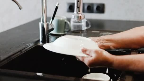 家庭主妇用海绵把盘子放在水槽里洗 — 图库视频影像