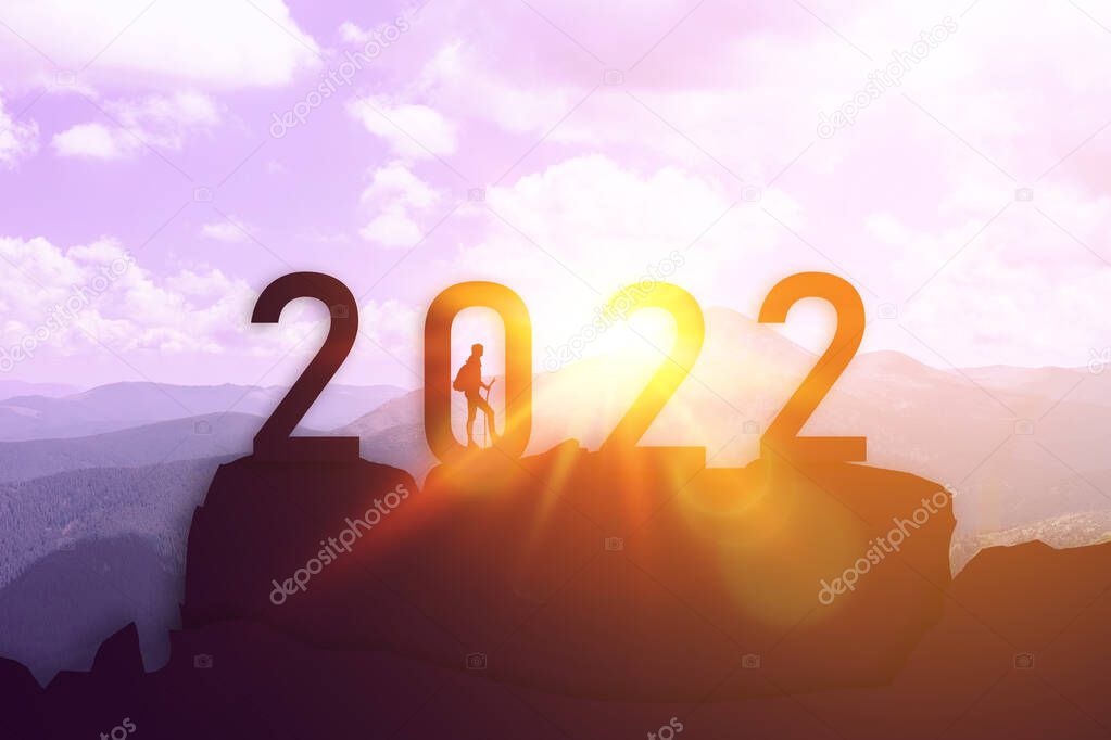 Successful lucky man reached the top in 2022 abstract background. Business start up or goal to success. Happy new year and holiday celebration concept