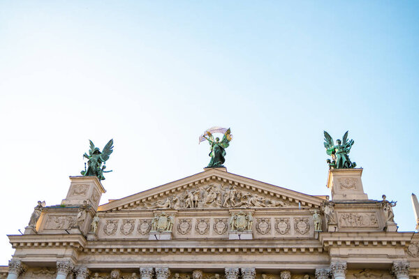 Old gable of Lviv Theatre of Opera and Ballet against blue sky, horizontal image