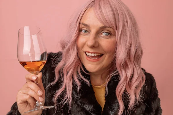 冬の衣装を着たかなり若い女性の肖像画は ピンクの背景にシャンパンワインとガラスを祝い — ストック写真
