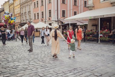 Tarihi şehir Lviv, Ukrayna 'da bir cadde. İnsanlar güneşli bir yaz gününde şehir caddesinde yürürler.