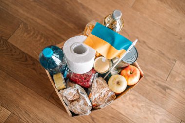  Ukraynalı çocuklar ve insanlar için farklı market ürünlerinin olduğu kağıt dolu bir bağış kutusu. Ukrayna Bağışı. Gönüllü olmak, bağışta bulunmak, yardım amaçlı mülteciler, savaş..