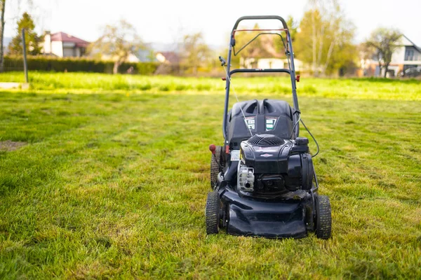 Cutting the grass gardening activity, lawn mower cutting the grass. — Stockfoto