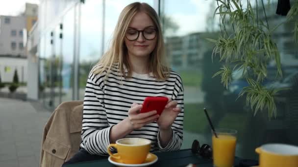 Charming Young Girl Using Mobile Phone While Sitting Cafe Outdoors — Stock videók