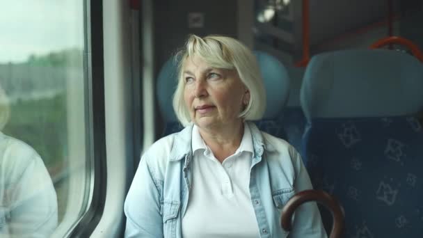 Sad 50S 60S Senior Woman Relaxing Looking Out Train Window – stockvideo