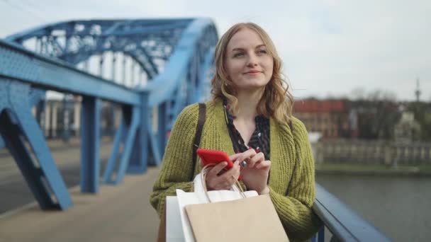 Shopping European Blonde Woman Sale Paper Bags Using Smart Phone — стоковое видео
