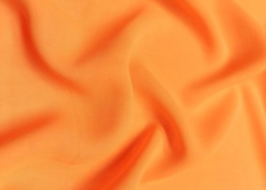 Turuncu buruşuk ya da dalgalı kumaş arkaplan. Soyut keten kumaş yumuşak dalgalar. Saten, ipek ve pamuk hazineleri. Pürüzsüz zarif ipek ya da atlas lüks kumaş dokusu. Çarşaflar ya da battaniye