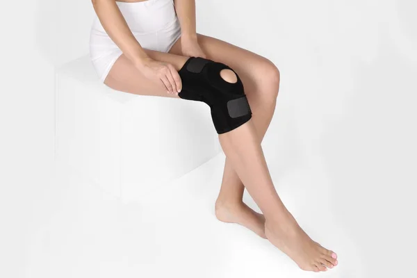 Knee Support Brace on leg isolated on white background. Orthopedic Anatomic. Braces for knee fixation, injuries and pain. Knee Joint Bandage Sleeve. Elastic Sports — Stock Photo, Image