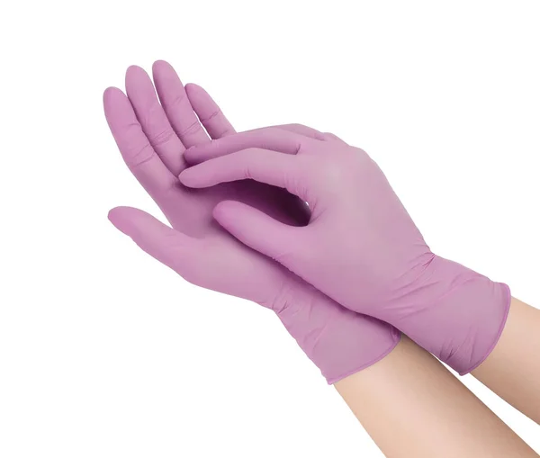 Guanti medici. Due guanti chirurgici rosa isolati su sfondo bianco con le mani. Produzione di guanti di gomma, la mano umana indossa un guanto di lattice. Medico o infermiere indossare guanti protettivi — Foto Stock