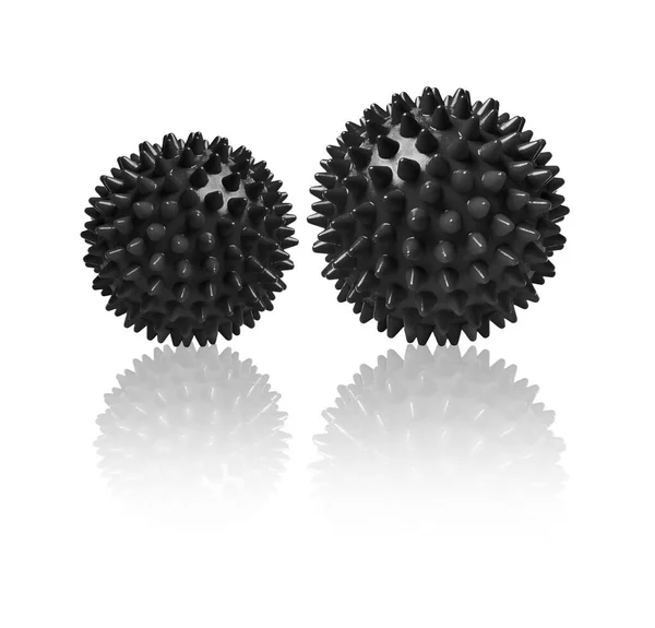 Twee zwarte stekelige massageballen geïsoleerd op wit. Concept van fysiotherapie of fitness. Close-up van een kleurrijke rubberen bal voor hond tanden op een witte achtergrond. Corona virus model. Sneeuwvlok — Stockfoto
