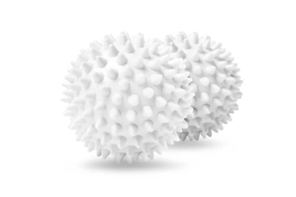 Twee witte stekelige massageballen geïsoleerd op wit. Concept van fysiotherapie of fitness. Close-up van een kleurrijke rubberen bal voor hond tanden op een witte achtergrond. Corona virus model — Stockfoto