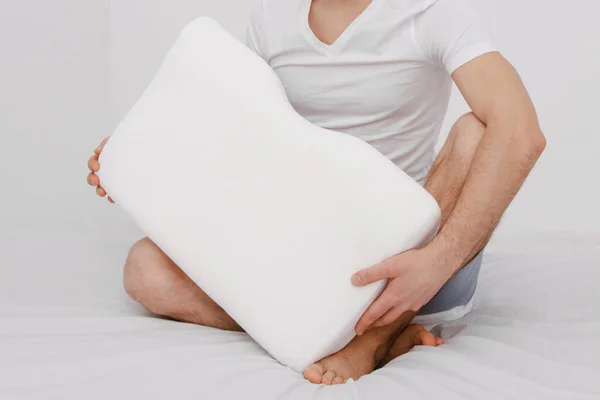 Orthopedic Pillow with a Memory Effect. Medical treatment pillow for sleep. Comfort Memory Pillow under the head with a recess under the shoulder isolated on white background. Sleeping Support Pillow