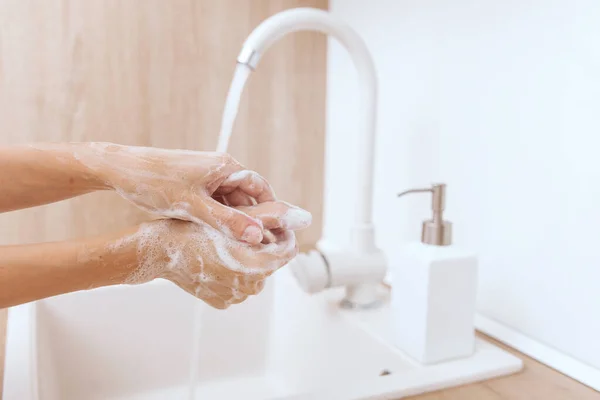 Washing hands under the flowing water tap. Hygiene concept hand detail. Washing hands rubbing with soap for corona virus prevention, hygiene to stop spreading corona virus in or public wash room — Stock Photo, Image