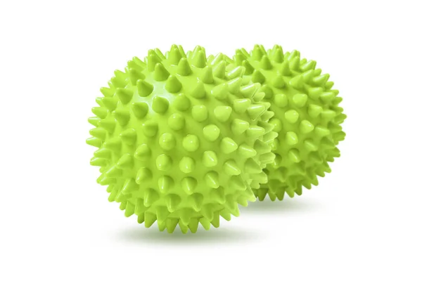 Twee groene stekelige massageballen geïsoleerd op wit. Concept van fysiotherapie of fitness. Close-up van een kleurrijke rubberen bal voor hond tanden op een witte achtergrond. Corona virus model — Stockfoto