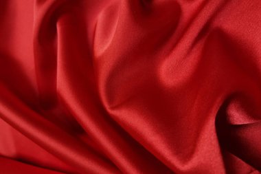 Kırmızı buruşuk ya da dalgalı kumaş arkaplan. Soyut keten kumaş yumuşak dalgalar. İpek atlası ya da streç Jacquard. Pürüzsüz lüks kumaş dokusu. Pankart veya reklam kavramı