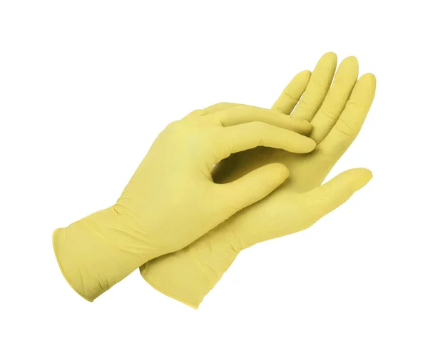 Rękawiczki. Dwie żółte rękawice chirurgiczne odizolowane na białym tle dłońmi. Wytwarzanie gumowych rękawic, ludzka ręka nosi lateksową rękawicę. Lekarz lub pielęgniarka zakładający rękawice ochronne — Zdjęcie stockowe
