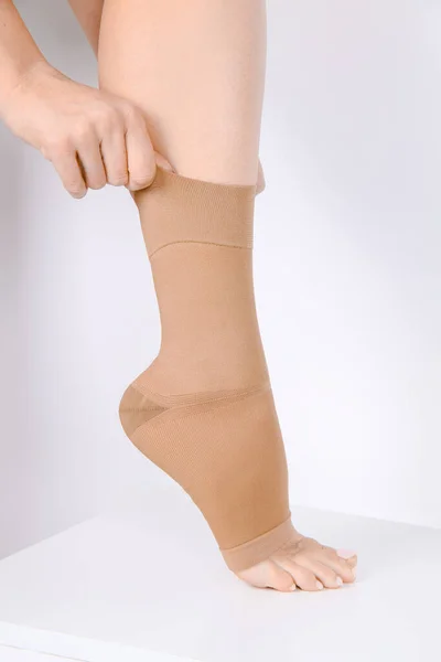 Orthopedic Ankle Brace. Medical Ankle Bandage. Medical Ankle Support Strap Adjustable Wrap Bandage Brace foot Pain Relief Sport. Leg Brace isolated on white background. Trauma Ankle orthosis. Injury Stock Image
