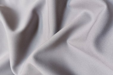 Gri buruşuk ya da dalgalı kumaş arkaplan. Soyut keten kumaş yumuşak dalgalar. İpek atlası ya da streç Jacquard. Pürüzsüz lüks kumaş dokusu. Pankart veya reklam kavramı