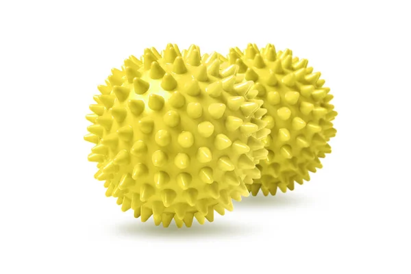 Twee gele stekelige massageballen geïsoleerd op wit. Concept van fysiotherapie of fitness. Close-up van een kleurrijke rubberen bal voor hond tanden op een witte achtergrond. Corona virus model — Stockfoto