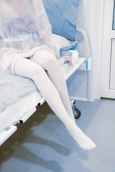 Anti-embolic surgery compression hosiery. Operating room in a hospital. Surgical equipment with operating table. Medical device for emergency patient in blue tone style. Clinic interior background Royalty Free Stock Photos
