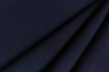Mavi buruşuk ya da dalgalı kumaş arkaplan. Soyut keten kumaş yumuşak dalgalar. Gabardine yün kumaşı. Merino ipliği. Pürüzsüz lüks kumaş dokusu. Pankart veya reklam kavramı