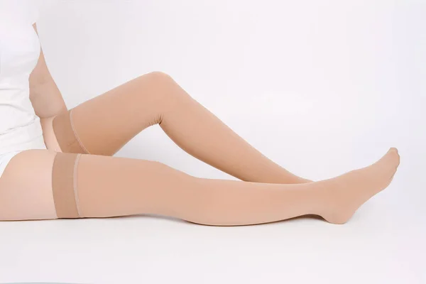 Beige compression stockings isolated on a white background Royalty Free Stock Images