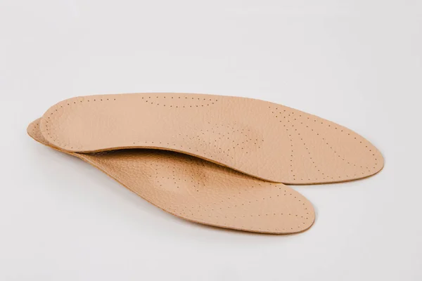 Insoles isolated on a white background. Medical orthopedic insoles. Foot care. Insole cutaway layers. Treatment and prevention of flat feet and foot diseases. Inner soles of shoes — Stock Photo, Image
