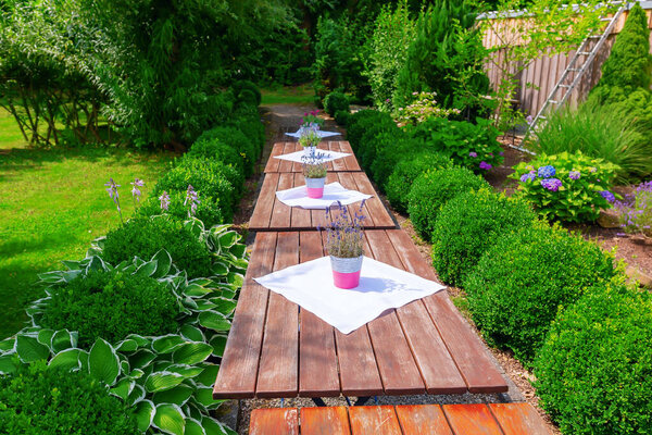 row of decorated tables in a garden