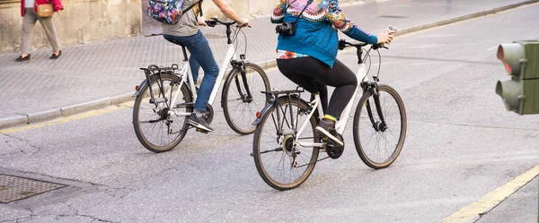 tourists cycling on a city street